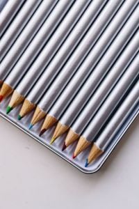Silver Colored Pencils and Creative Stationery on a Minimalist Desk