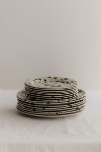 Kaboompics - Stacked Green Splatter Plates with Generous Neutral Copy Space