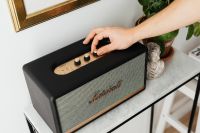 Kaboompics - Black speaker on marble table, white wall, sculpture, hand