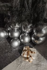 Kaboompics - Silver Christmas Tree Base with Gift and Silver Balloons