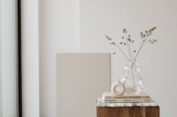 Kaboompics - Neutral Interior Still Life with Glass Vase, Books and Ring Sculpture