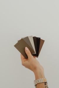 Kaboompics - Hand Holding Brown Paint Color Swatch Fan