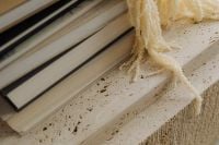 Kaboompics - Close-Up of Travertine Surface, Books and Fringed Textile