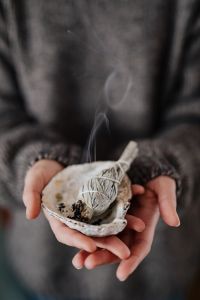 Kaboompics - Long Wisps of Smoke against Soft Gray Knitwear, Minimal Spiritual Ritual Backdrop