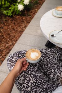 Kaboompics - Heart Latte in a Woman's Hand at an Outdoor Cafe