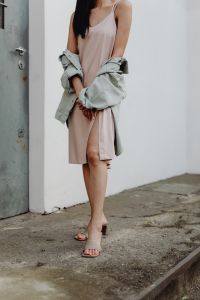 Kaboompics - Cropped Fashion Model Holding Gray Jacket over Pale Dress on Concrete Steps