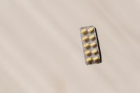 Kaboompics - Single Blister Pack of Yellow Tablets on Beige with Copy Space for Pharmacy Campaign