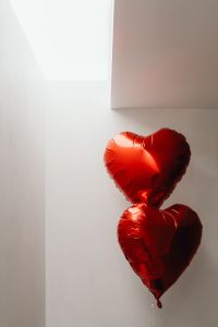 Kaboompics - Pair of Red Heart Balloons in a White Room