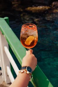 Kaboompics - Aperol Glass by the Pier Railing above Teal Water