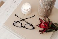 Kaboompics - Black Glasses and Red Flowers on Art Books