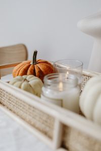Kaboompics - Close Up of Pumpkins and Candle in a Wicker Tray