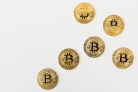 Kaboompics - Scattered Gold Bitcoin Coins on White Background