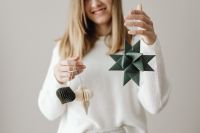 Kaboompics - Woman Holding Dark Green Paper Christmas Ornament