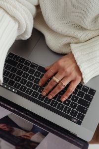 Kaboompics - Close-Up of Hand Typing on Laptop with Gold Rings