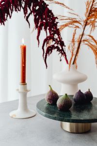 Kaboompics - Whole Fresh Figs On Green Marble Table With Candle