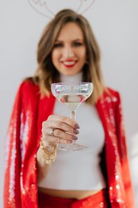 Kaboompics - Champagne Coupe in Focus, Red Suit Portrait Blurred Behind