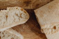 Kaboompics - Rustic Bread and Slices on a Wooden Cutting Board