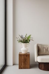 Kaboompics - Wildflower Vase on Wooden Pedestal with Armchair and Window Frame