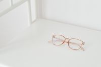 Kaboompics - Rose-Gold Eyeglasses on a Bright White Desk with Soft Window Light and Open Copy Space