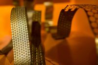 Kaboompics - Bended golden metal on an orange background