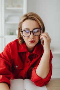 Kaboompics - Woman Talking on Phone with Laptop Reflected in Glasses