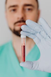Kaboompics - Doctor Presenting Blood Sample in Gloved Hand