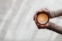 Kaboompics - Hands Holding a Lit Candle on Beige Blanket
