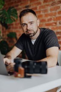 Kaboompics - Male Photographer Portrait with Camera at Home Office Desk