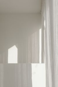 Kaboompics - White Wall and Sheer Curtains with Geometric Sunlight