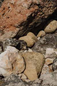 Kaboompics - Sunlit Coastal Boulders Beneath a Deep Rock Overhang