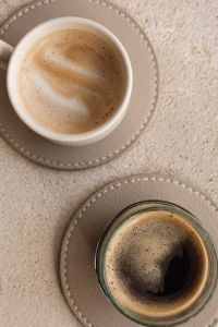 Kaboompics - Cream Latte Cup and Espresso Glass on Beige Stitched Coasters