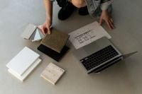 Kaboompics - Architectural Material Selection Workspace with Laptop and Floor Plan
