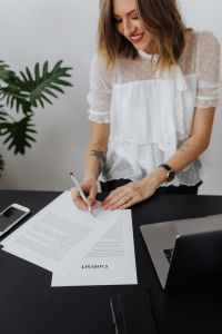 Kaboompics - Businesswoman Completing Paperwork Beside Laptop