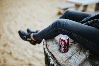Kaboompics - Close View of Cola Can on Weathered Wood with Jeans and Sand