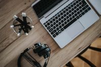 Kaboompics - Silver Acer laptop on a wooden desk with pencils and black headphones