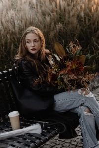 Kaboompics - Woman Sitting with Autumn Bouquet and Coffee by Ornamental Grass