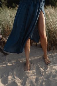 Kaboompics - Barefoot Legs in Blue Kaftan Dress on Sand