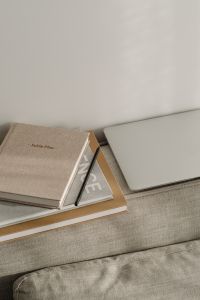 Kaboompics - Linen Planner, Pencil and Closed Laptop on a Textured Sofa