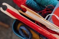 Kaboompics - Green Yarn and White Fringe on a Loom