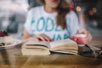 Kaboompics - Woman Reading an Open Book with Coffee and Eyeglasses