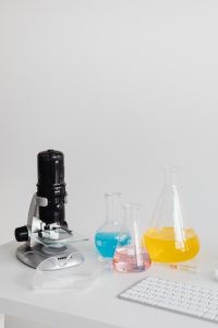 Kaboompics - Microscope and Laboratory Glassware on White Background