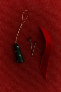 Kaboompics - Mini Christmas Tree Ornament with Sewing Pins and Red Ribbon