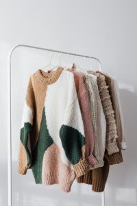 Kaboompics - Soft-Colored Sweaters Arranged on Hangers