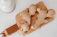 Kaboompics - Fresh Ginger Root on a Wooden Board with a Kitchen Grater, Overhead View