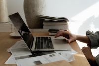 Kaboompics - Laptop and Interior Design Papers on a Sunlit Creative Workspace