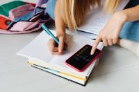 Kaboompics - Girl Doing Homework with Calculator at Home