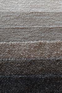 Kaboompics - Overlapping Neutral Bouclé Upholstery Fabric Swatches