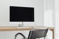 Kaboompics - Bright Computer Desk Setup with iMac and Chrome Chair by Sheer Curtains