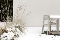 Kaboompics - Snow-Covered Patio Table and Chairs Beside Ornamental Grasses, Winter Garden