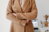Kaboompics - Close-Up Crossed Arms and Glasses in Camel Blazer